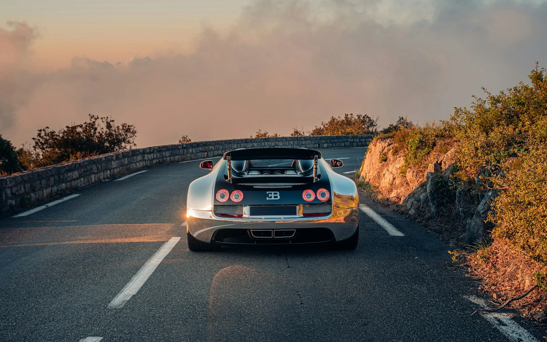 Rear view of the polished aluminium Bugatti Veyron Grand Sport Vitesse at sunset